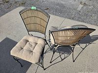 Two steel frame chairs with cushions side by side on concrete
