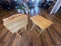 Folded trays on stand beside an opened tray table