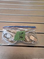 Five coiled white USB-A to 30-pin cables in zip bag