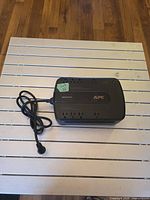 Top view showing APC Back-UPS 550 with outlets and cord