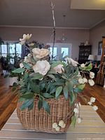 Front view of cream silk floral arrangement in wicker basket