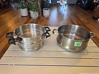 All three stainless steel cookware pieces on table