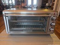 Front view of Black & Decker Crisp 'n Bake air fryer convection oven with glass door and control knobs