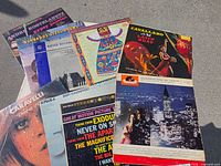 Top view of spread showing eight LP covers (Andre Kostelanetz, steel drums compilation, children’s album, Carmen Cavallaro, Caravelli, Bert Kaempfert, Wonderland By Night, partial others)