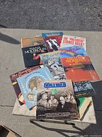 Top view of assorted LP records and 45s spread on pavement