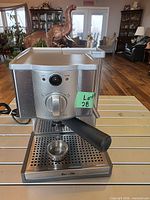 Front view of Breville Cafe Roma espresso machine with portafilter handle inserted and drip tray in place
