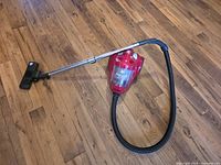 Vacuum assembled with hose, wand and floor nozzle on hardwood floor