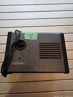Front view showing Caframo logo, control dial, indicator light, grille, and power cord
