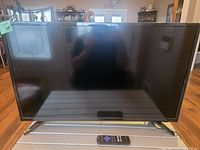 Front view of Insignia 32" Roku TV on stand