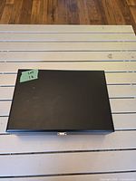 black presentation case closed on white slatted surface