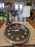 Clock and both lamps on table