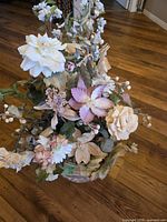 Front view of entire artificial floral arrangement showing flowers and pot