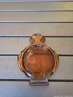 Front view of Olympea perfume bottle showing liquid level and design