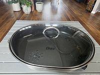 Closed skillet showing glass lid with Oster logo