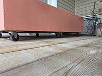 Side view of long wooden planter box on caster wheels