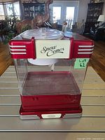 Front view showing Snow Cones sign, red body, clear panels