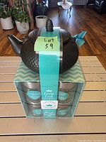 Boxed set showing teapot on top of tea tins