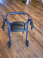 Front view of blue Hugo rollator walker showing seat, backrest and front wheels