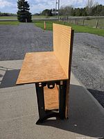 Side view of plywood workbench with pegboard and Rubbermaid frame