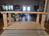 Full view of wooden slat rack showing two tiers and side supports