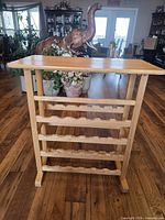 front view of solid wood wine rack showing four bottle tiers and top shelf