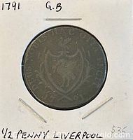 Coin in holder showing shield side with Latin legend