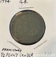 Coin in holder, reverse ship side visible