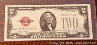 Obverse of 1928G $2 note showing Jefferson portrait, red seal, serial number