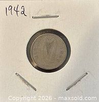 Front view of coin in holder showing obverse harp side with date