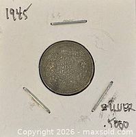 Coin in cardboard flip showing reverse with date 1943
