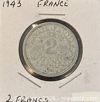 Coin in holder, full view with hand-written year and country, obverse visible