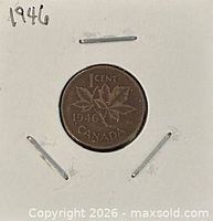 Coin in flip showing reverse with maple leaves and date 1946