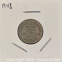 Coin in 2x2 holder showing reverse with crowned monogram and date