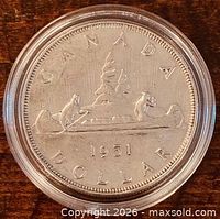 Reverse of 1951 silver dollar showing canoe design and date