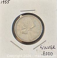 Obverse of coin showing caribou reverse side in holder