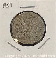 Coin in cardboard flip showing reverse side Tudor rose design and 1957 date