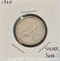 Coin in cardboard holder, front reverse view showing caribou design