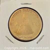 Obverse view of medal displaying capsule, text and date