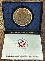 Medal in open blue presentation case with brochure