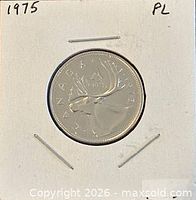 Coin reverse showing caribou and 1975 date in cardboard flip