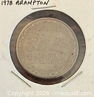 Obverse view of coin in holder showing trillium and flag