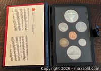 Open display case showing 7 proof coins and info card