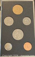 Reverse sides of six coins in specimen set within black foam display