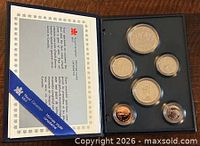 open display case showing six coins and information card