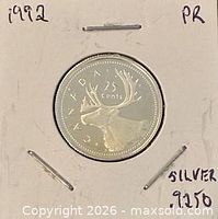 Reverse of 25-cent coin showing caribou and denomination