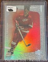 Front of holographic Gordie Howe Supreme Milestones card in plastic sleeve