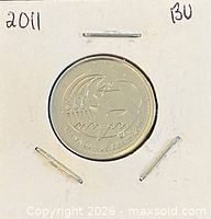 Coin in 2x2 holder, reverse side visible showing orca whale design