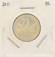 Full coin in cardboard flip displaying date annotation