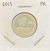 Coin in cardboard flip marked 2013 PR showing reverse