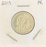 Obverse and reverse views of the 2013 proof quarter in flip